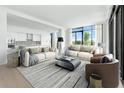 Spacious living room with an open floor plan, modern decor, and abundant natural light from large windows at 2425 Peachtree Ne Rd # 1503, Atlanta, GA 30305