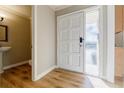 Bright entryway featuring hardwood floors, neutral walls, a white front door, and a half bath with a pedestal sink at 3312 Northcrest Rd # A, Atlanta, GA 30340