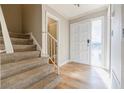 Inviting entryway with a staircase, neutral paint, and a white front door with glass sidelight providing plenty of natural light at 3312 Northcrest Rd # A, Atlanta, GA 30340