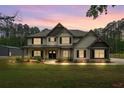 Charming two-story home with a beautifully landscaped yard, porch, and sunset sky at 337 Paynes Lake Rd, Carrollton, GA 30116