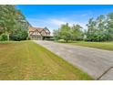 Expansive front yard with a long driveway leading to a beautiful, well-maintained home at 17 River Walk Pkwy, Euharlee, GA 30145