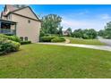 Well-maintained side yard with lush green grass and mature landscaping, offering a serene outdoor space at 17 River Walk Pkwy, Euharlee, GA 30145