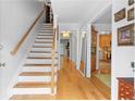 Inviting entryway featuring wood floors, a staircase with white risers and a wood railing and an open view at 2779 Bentley Se Pl, Marietta, GA 30067