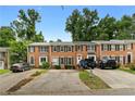 Alluring brick townhomes featuring black shutters and trimmed bushes, complemented by ample parking at 2779 Bentley Se Pl, Marietta, GA 30067