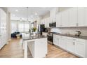 Bright kitchen featuring stainless steel appliances, granite countertops, and white cabinetry at 3313 Park Pointe Cir, Scottdale, GA 30079