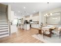 Open-concept kitchen and dining area with modern light fixtures and wood floors at 3313 Park Pointe Cir, Scottdale, GA 30079