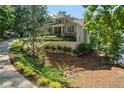 Desirable home features professional landscaping, retaining walls, and driveway at 7815 Bamby Rd, Cumming, GA 30041