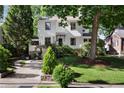 Charming home with a beautifully landscaped front yard, mature trees, and a welcoming entrance at 820 Highland Ne Ter, Atlanta, GA 30306