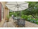 Outdoor back deck with table, chairs and shade for entertaining at 117 Laguna Springs Dr, Woodstock, GA 30188