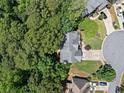 Bird's eye view of a house in a cul-de-sac, surrounded by lush green trees, offering privacy and tranquility at 117 Willow View Ln, Canton, GA 30114