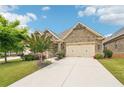 Beautiful brick home with a well-kept lawn and a two-car garage at 332 Rosshandler Rd, Suwanee, GA 30024