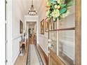 Inviting hallway features hardwood floors, detailed trim, and natural light streaming from the front door at 332 Rosshandler Rd, Suwanee, GA 30024