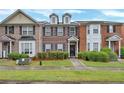 Traditional brick townhome featuring a well-maintained lawn and an inviting entrance at 4713 Liberty Square Dr, Acworth, GA 30101
