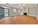 Bright living room with hardwood floors, fireplace, and built-in shelving at 4713 Liberty Square Dr, Acworth, GA 30101