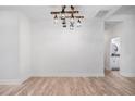 Dining room with wood-look floors and modern industrial-style lighting at 5745 Westwood Dr, Cumming, GA 30040