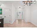 Open entryway with wood-look floors and a modern light fixture at 5745 Westwood Dr, Cumming, GA 30040