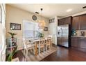 Cozy dining area featuring stylish lighting, a dining table, and sleek stainless steel appliances at 106 Cessna Dr, Canton, GA 30114