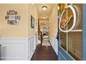 Inviting entryway with hardwood floors, decorative wreath, and white wainscoting at 106 Cessna Dr, Canton, GA 30114