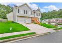 Two-story home with a well-maintained lawn and driveway leading to a two-car garage at 2535 Brookgate Xing, Ellenwood, GA 30294