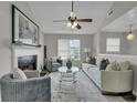 Cozy living room with a fireplace, ceiling fan, and comfortable seating arrangement at 2535 Brookgate Xing, Ellenwood, GA 30294