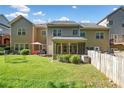 Fenced backyard with lush green lawn and screened in porch at 100 Trailside Way, Hiram, GA 30141