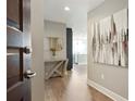 Hallway boasts modern decor, light hardwood floors, and a glimpse of the open kitchen at 1080 Peachtree Ne St # 1402, Atlanta, GA 30309