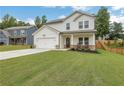 Well-maintained home with a neat lawn, complemented by a charming covered porch and a two-car garage at 16 Dovecrest Way, Acworth, GA 30101