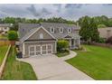Charming home features a two-car garage and a well-manicured front lawn and an inviting front porch at 4721 W Lakeshore Dr, Acworth, GA 30101