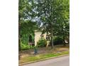 View of the back side of the house with a deck in the trees behind the home at 5580 Jamerson Dr, Atlanta, GA 30349