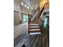 Bright foyer featuring wood staircase, wrought iron spindles and an airy feel at 5580 Jamerson Dr, Atlanta, GA 30349