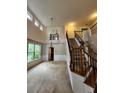Open foyer featuring high ceilings, staircase with railing, and lots of natural light at 5580 Jamerson Dr, Atlanta, GA 30349