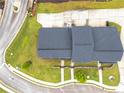 Aerial view of a home showcasing its roof, driveway, and meticulously maintained landscaping at 6330 Garden Cir, Douglasville, GA 30135
