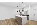 Contemporary kitchen with a large island, stainless steel appliances, and modern pendant lights at 112 Rogers Ne St # 304, Atlanta, GA 30317