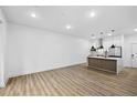 Spacious living area with modern flooring and a view of the stylish kitchen with stainless steel appliances at 112 Rogers Ne St # 304, Atlanta, GA 30317