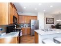 Well-equipped kitchen featuring stainless steel appliances, granite countertops, and wooden cabinetry at 240 Orchard Dr, Covington, GA 30014