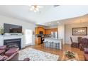 Bright, open floor plan featuring a fireplace, kitchen island with bar stools, and hardwood floors at 240 Orchard Dr, Covington, GA 30014