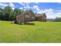 This brick home has a finished basement and is situated on a lush green lawn at 3950 Chattahoochee Rd, Cumming, GA 30041
