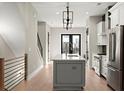Modern kitchen boasts stainless appliances, a gray island, and chic lighting at 2333 Mason Dr # D26, Atlanta, GA 30316