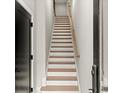 Bright staircase featuring wood treads, white risers, light walls, and a wood handrail at 2333 Mason Dr # D26, Atlanta, GA 30316