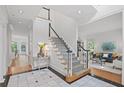 Grand foyer with black and white tile, staircase, and views of the living room and other spaces at 310 Ivy Brooke Ct, Atlanta, GA 30342