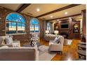 Cozy living room with exposed brick, wooden beams, and city views at 3180 Mathieson Ne Dr # 1401, Atlanta, GA 30305