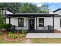 Charming front porch with black trim and a decorative front door for welcoming guests at 4946 Lake Ridge Trail, Lilburn, GA 30047
