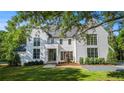 A bright, two-story home featuring a black roof and well-manicured lawn and landscaped grounds at 530 Old Cobblestone Dr, Atlanta, GA 30350