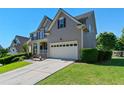Side view of a two-story home with a well-manicured lawn and attached two-car garage at 829 Castlebottom Dr, Lawrenceville, GA 30045