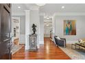 Inviting foyer with rich hardwood floors, elegant trim, and views into the kitchen and living spaces with an art collection at 1070 Standard Ne Dr, Brookhaven, GA 30319