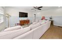 Bright living room featuring a large sectional sofa, hardwood floors, and stylish decor at 1649 Beecher Sw St, Atlanta, GA 30310