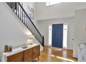 Bright foyer with a blue front door, staircase, and modern furnishings at 1867 N Creek Cir, Alpharetta, GA 30009