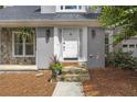 Close up of a home's front entrance, featuring a stone pathway and beautifully detailed white door at 1867 N Creek Cir, Alpharetta, GA 30009