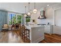 Open kitchen with stone countertops, stainless appliances, and hardwood floors, adjacent to a casual sitting area at 281 15Th Ne St # 202, Atlanta, GA 30309
