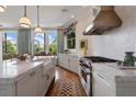 Bright kitchen featuring stone countertops, stainless appliances, and large windows with natural light at 281 15Th Ne St # 202, Atlanta, GA 30309